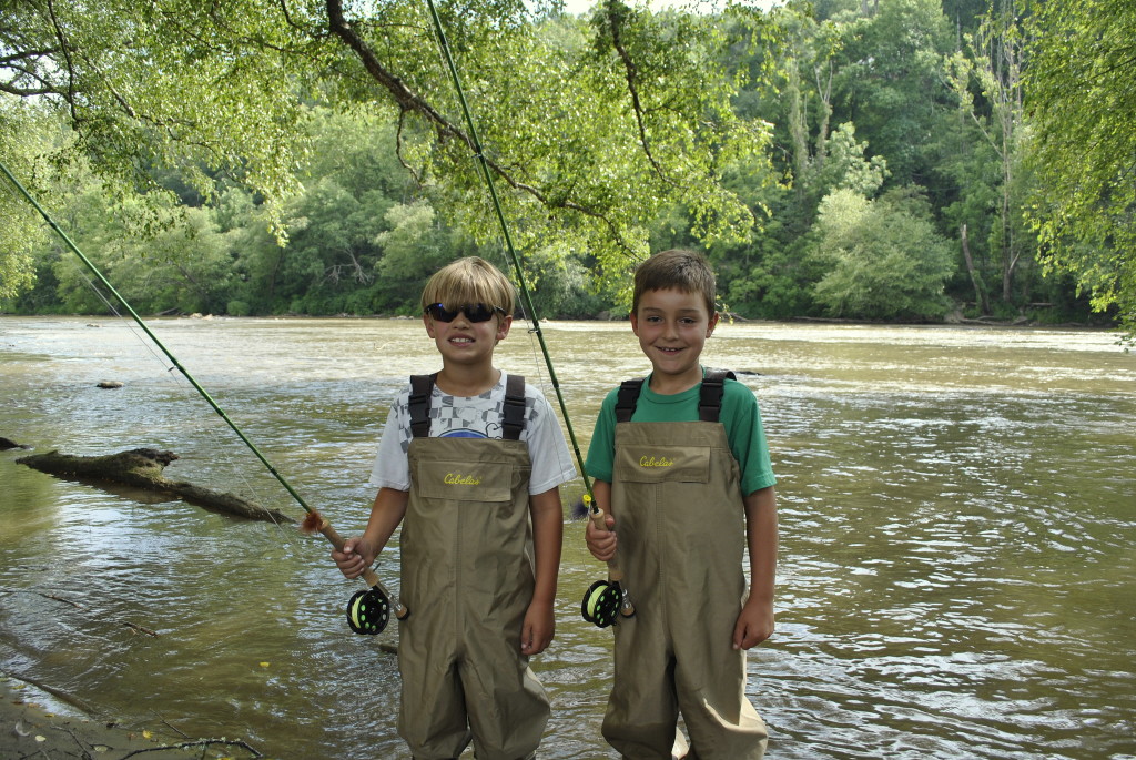 boys fishing river fly