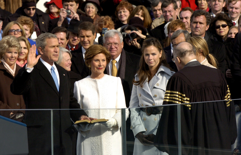 050120-F-6911G-128 Washington, D.C. (Jan. 20, 2005) - With his family by his side, President George W. Bush is sworn in for his second term as the 43rd President of the United States by U.S. Supreme Court Chief Justice William Rehnquist in Washington, D.C. More than 5,000 men and women in uniform provide military ceremonial support to the presidential inauguration, a tradition dating back to George Washington's 1789 Presidential Inauguration. U.S. Air Force photo by Tech. Sgt. Kevin J. Gruenwald (RELEASED)