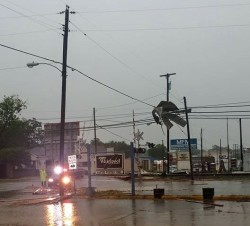 Debris in powers lines. Possibly from the roof of nearby Barber shop.