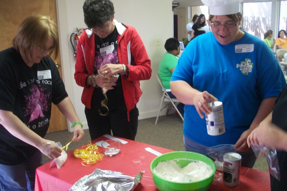 Childcare Conference participants enjoy the session of “Book Cooks” which incorporates math (measuring), hygiene (hand-washing), language arts (reading & listening), and science (reactions of ingredients when mixed or heated).