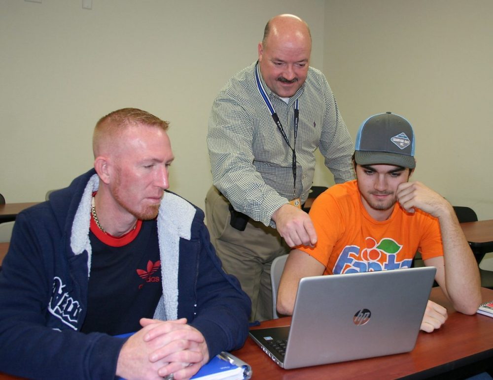 Students Jeff Carson and Ken Chapin, (l-r), listen to some important details from Instructor Howard Day in the criminal justice course at the PJC-Sulphur Springs Center. For information about this course or others offered at the campus, call 903-885-1232.