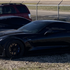 Two Black Corvettes Brave the Weather As Their Fate is Determined