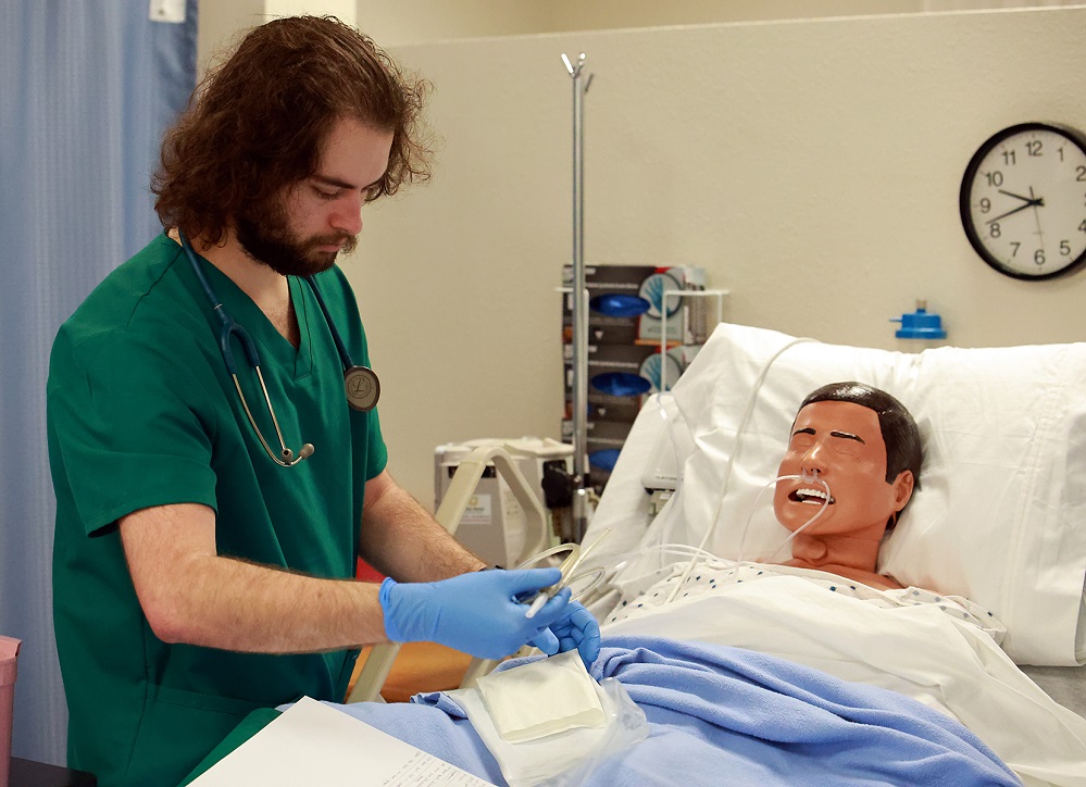 PJC associate degree nursing student Hayden Russell prepares medicine to add to an IV line in the PJC SIM lab.