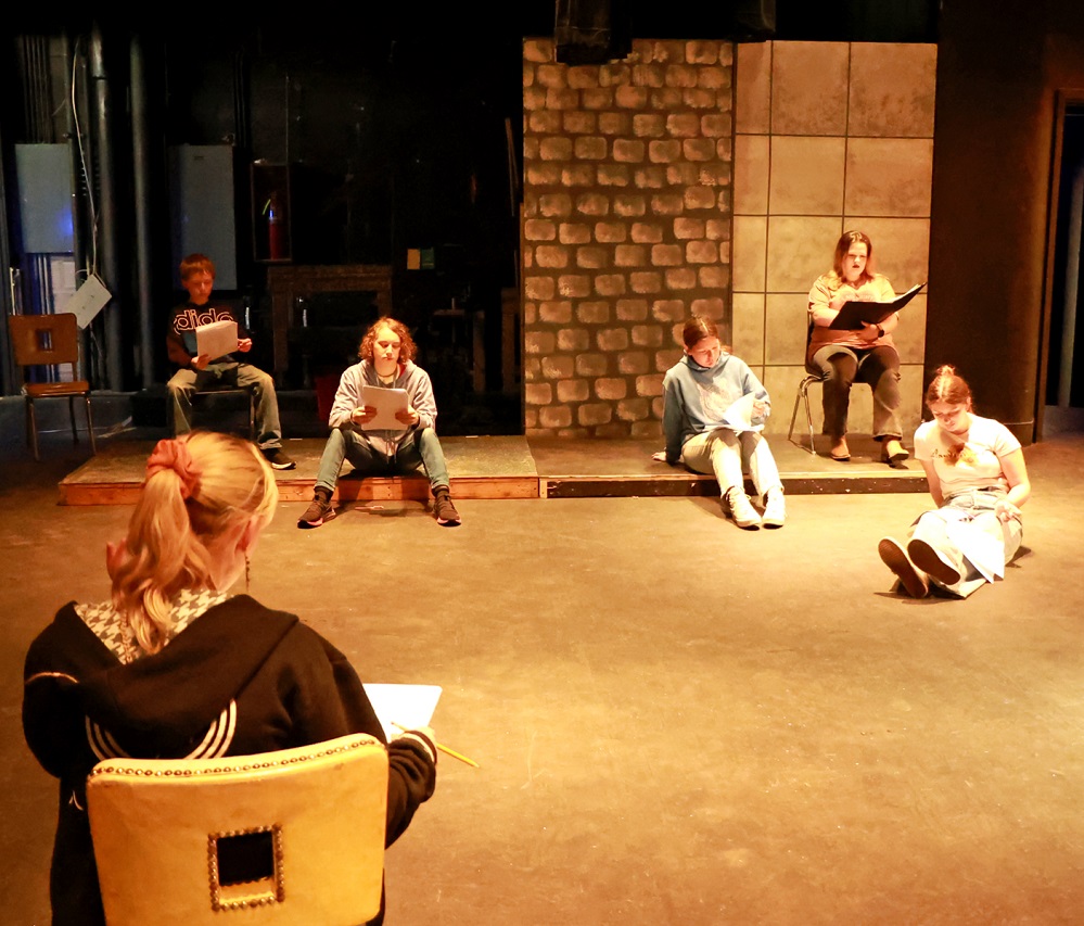 Addison Brown, foreground, listens to actors (l-r) Collin Henson, Kai Fornof, Emilee Stowell, Brenna Mills, and Libby Stowell do a read-through of "Heroes in the Pages."