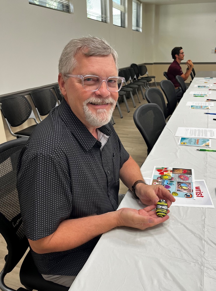 Foundation Board Member Steve Rutherford is buzzing with excitement as he shares his rock creation, a bumble bee. In addition to rock painting, desk stretches and breathwork were also discussed at the kickoff to the Summer of Health Fun sponsored by the Hopkins County Health Care Foundation.