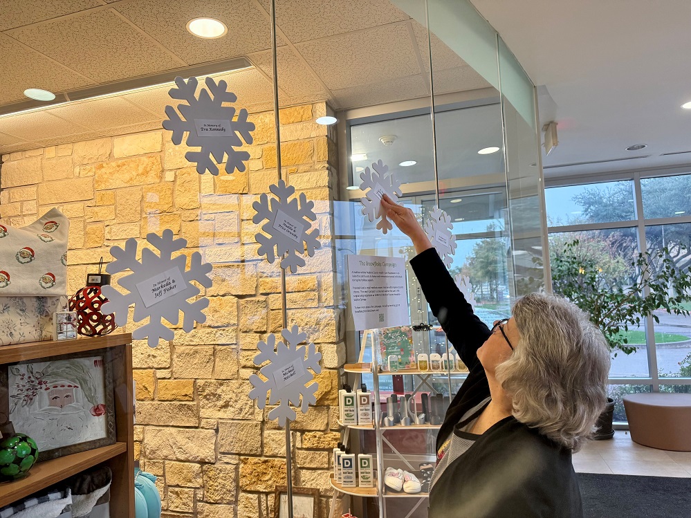 Susan Smith, also known as Mrs. Claus, hangs snowflakes on the windows of the Johnny Masters Gift Shop located at the front lobby of CHRISTUS Mother Frances Hospital – Sulphur Springs. Snowflakes will continue to grace the entry through mid-January. Honor or memorialize your friends and loved ones by purchasing snowflake recognition at Snowflake2025.GiveSmart.com or call 903-438-4799. What a wonderful way to spread joy and health this holiday season.