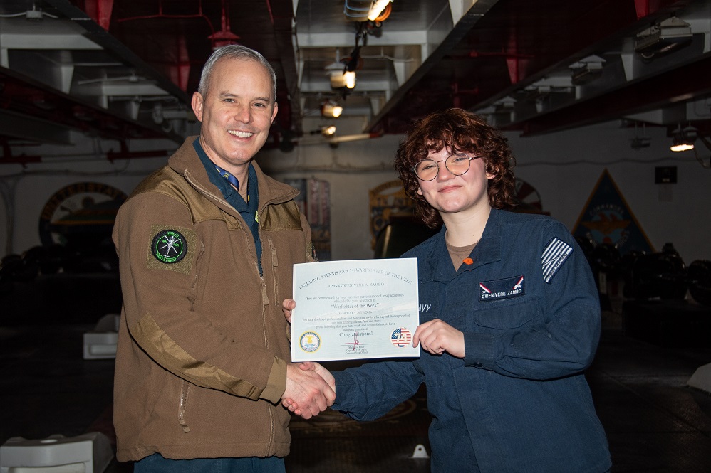 Capt. Matthew Kiser, commanding officer of the Nimitz-class aircraft carrier USS John C. Stennis (CVN 74), right, presents Gunner’s Mate Seaman Gwenivere Zambo with the warfighter of the week award aboard the ship in Newport News, Virginia, Feb. 26, 2026. John C. Stennis is in Newport News Shipbuilding conducting Refueling and Complex Overhaul to prepare the ship for the second half of its 50-year service life.